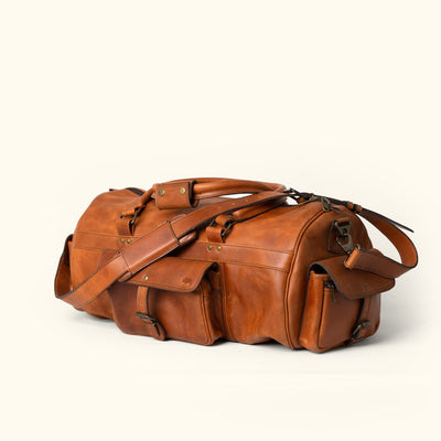 Durable Full Grain Leather Duffle: Autumn Brown, capacious, protective metal feet, premium stitching, timeless look for outdoor and urban adventures.
