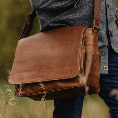 Classic amber brown leather satchel messenger, perfect for professional use with its large capacity and elegant look.