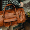 Premium Roosevelt Buffalo Leather Duffle Bag, Autumn Brown, perfect for travel, includes shoulder strap and multiple compartments.