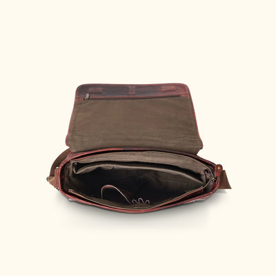 nterior view of a dark oak leather satchel messenger bag, revealing well-organized compartments, including a secure zipper pocket for valuable items.