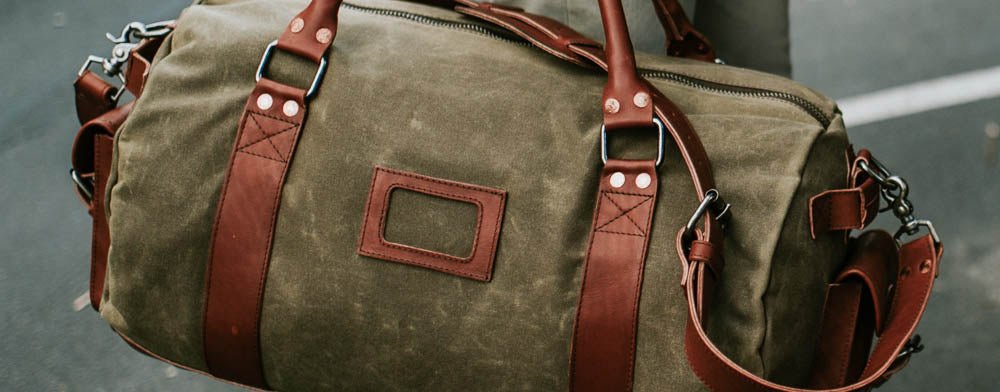 Waxed canvas duffle bag with leather trim
