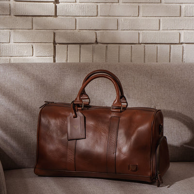 Sophisticated leather carryall, ideal for travel, with ample space, secure zippers, and a timeless design.