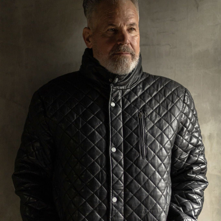 The Highlands Quilted Leather Jacket in black exudes timeless elegance with its meticulously crafted design, perfect for any discerning gentleman.