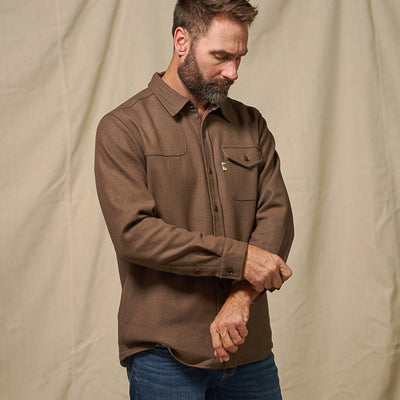 Styled outdoors photo of Gunnison brown wool-blend solid flannel shirt paired with jeans – rugged fall fashion look