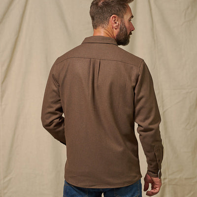 Back view of Gunnison solid brown flannel shirt highlighting shoulder yoke and full solid construction