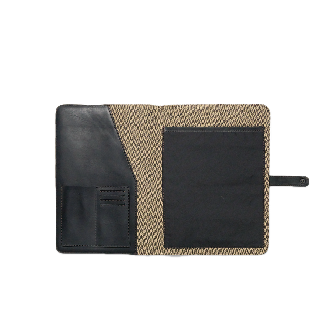 Two-tone leather and fabric pouch with a black flap on a white background