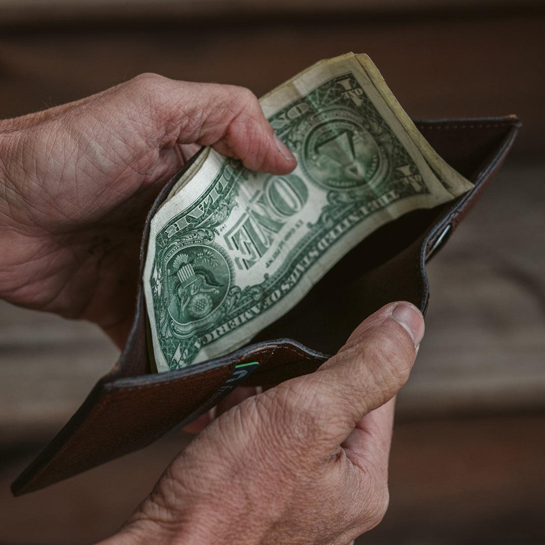 Durable dark brown bison leather trifold wallet, expertly crafted with fine stitching and practical layout.
