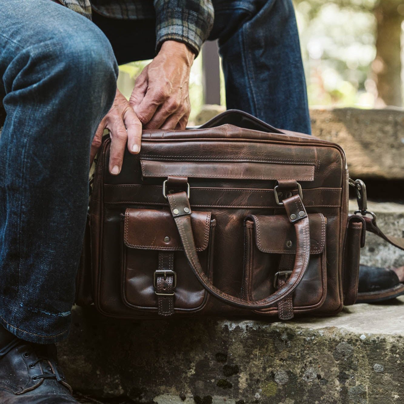 Roosevelt Buffalo Leather Pilot Bag in Dark Oak with buckled front pockets and two top handles