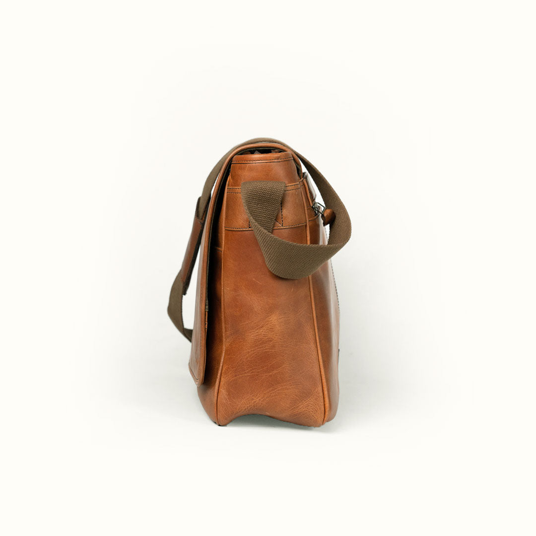 Stylish amber brown leather messenger bag with durable stitching and practical design.