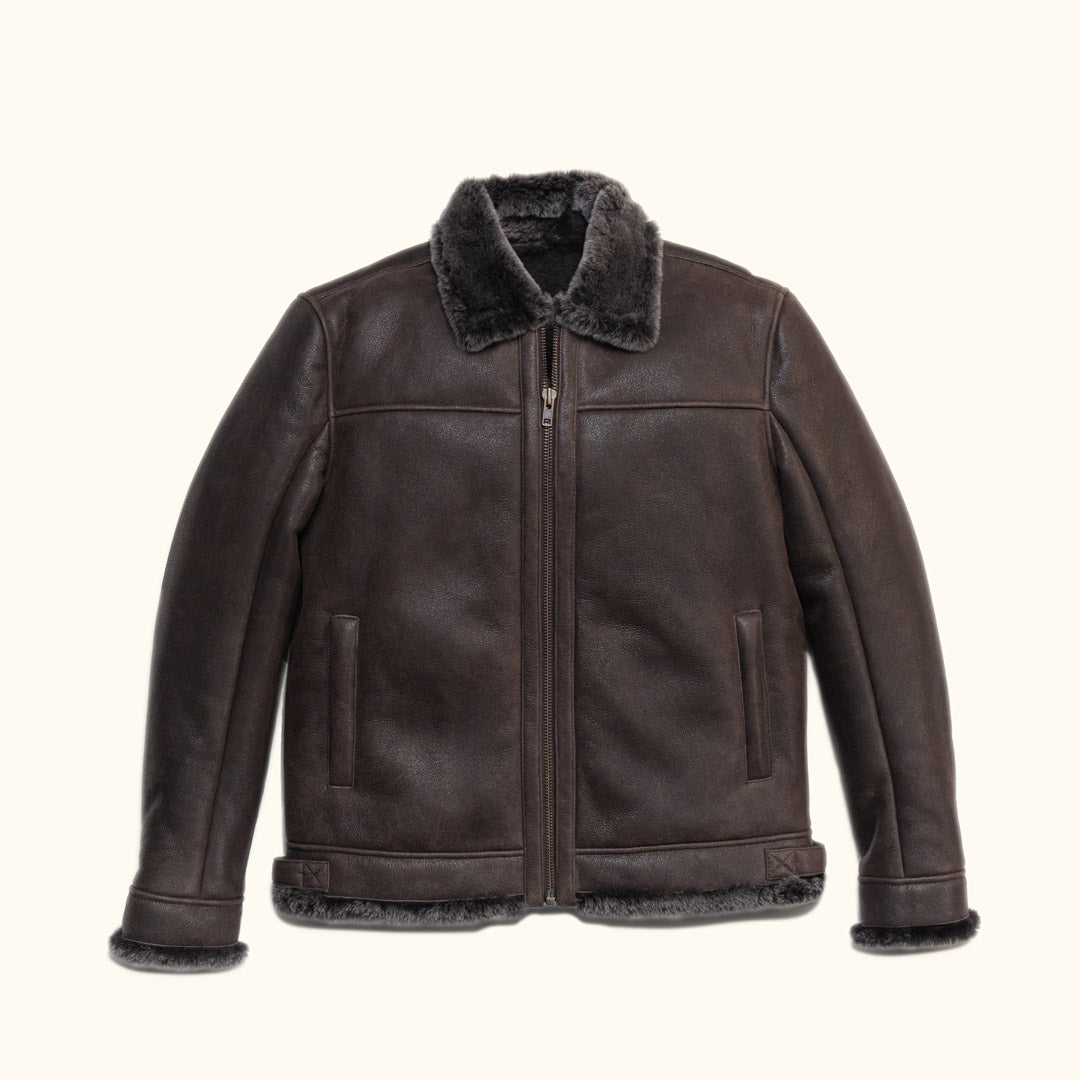Espresso brown shearling leather bomber jacket with a fur collar and full-length sleeves.