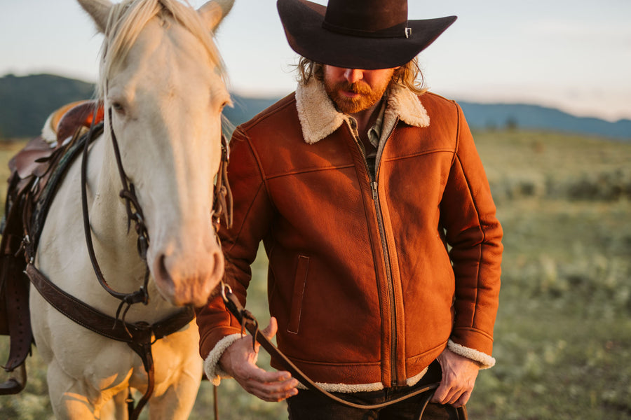 Shearling leather bomber jacket in whiskey brown with a natural wool collar