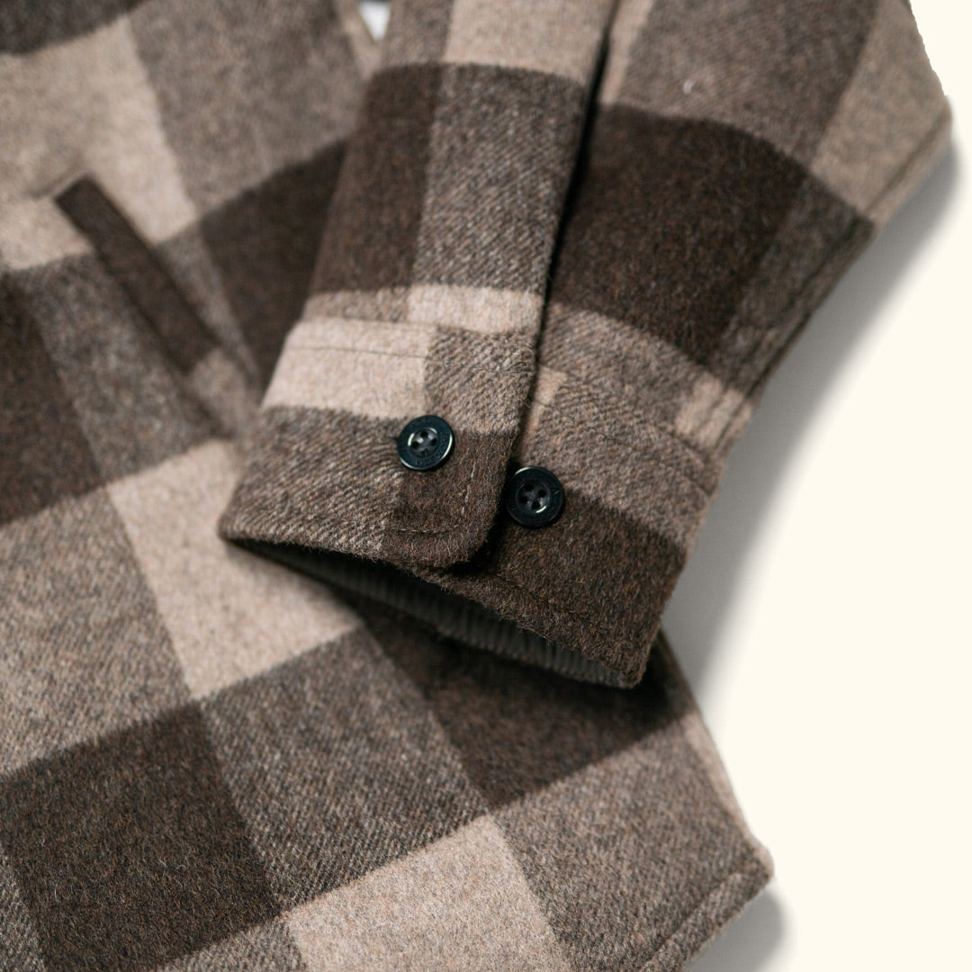 Flat lay of Yukon Wool Shirt Jac Buffalo Check showing distinctive buffalo check pattern and mid-to-heavy weight brushed wool fabric