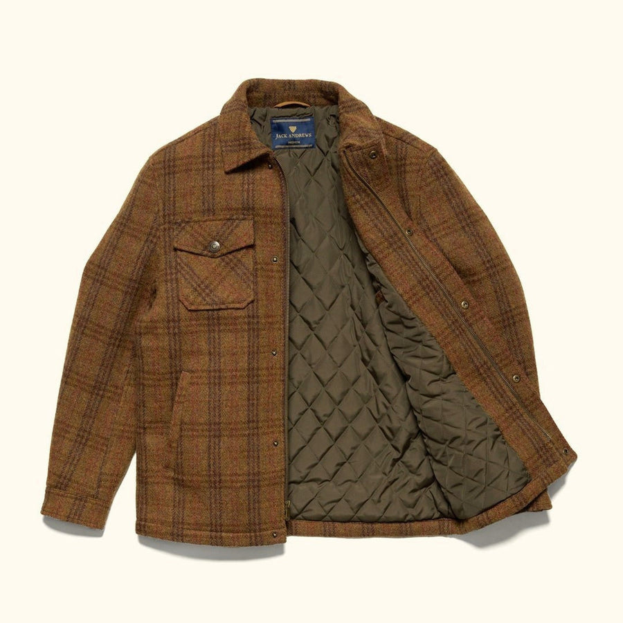 Man in the Aberdeen Wool Jacket in Dunbar Thicket over a cream turtleneck in a white stone arcade