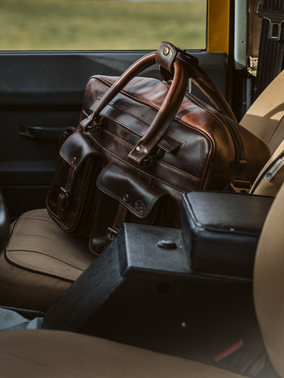 Roosevelt leather briefcase on the seat of a Land Rover