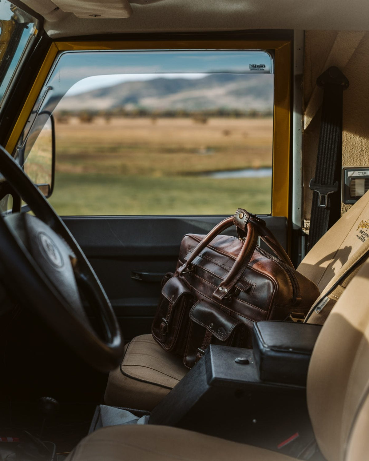 Buffalo Jackson leather briefcase on the passenger seat of a Land Rover