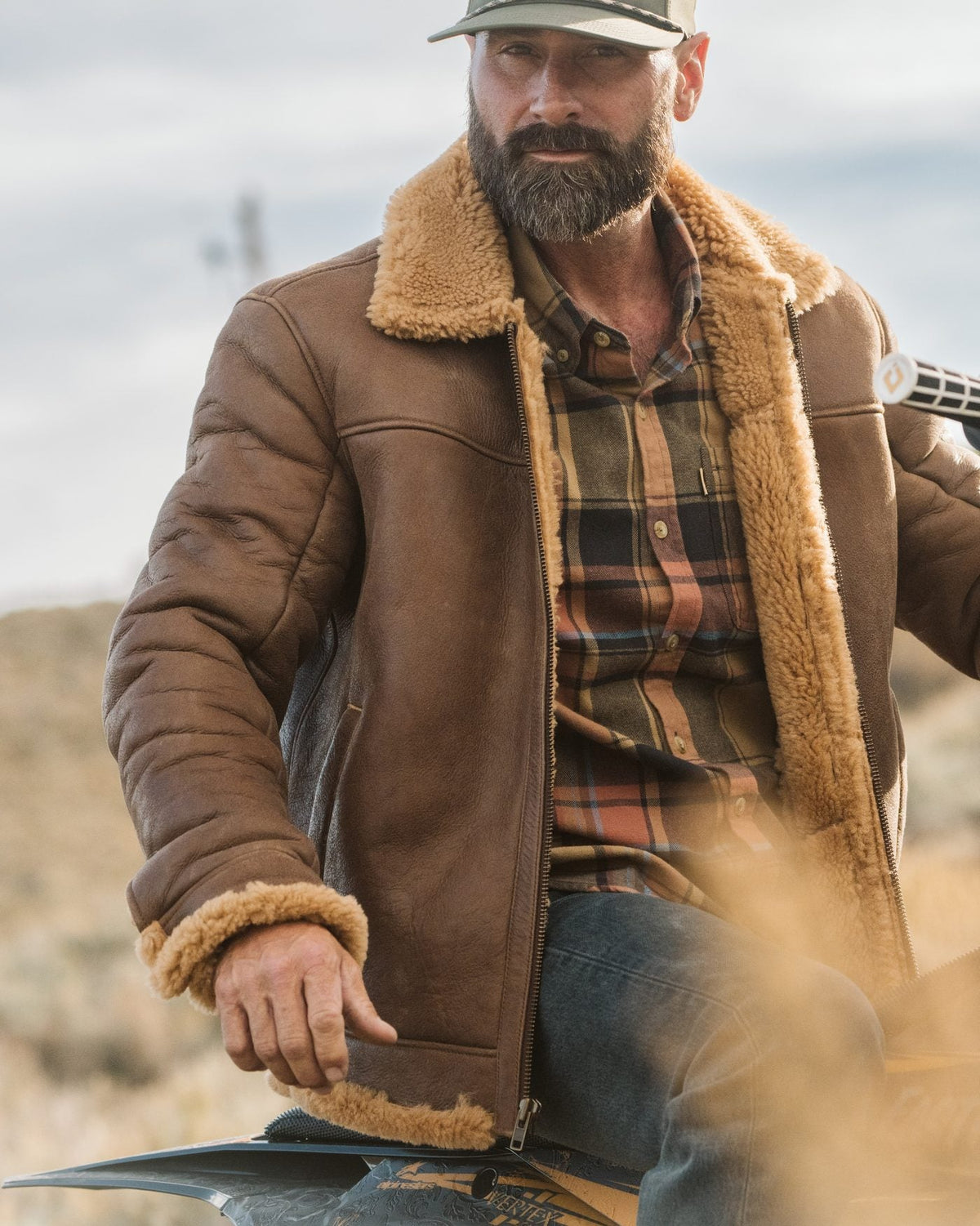 Man in a Buffalo Jackson shearling leather jacket on a motorbike in the sagebrush