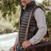 Classic black leather puffer vest, perfect for adding a touch of sophistication to any casual outfit.