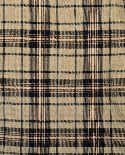 A close-up of a plaid fabric pattern with a beige base and intersecting black and thin tan stripes.