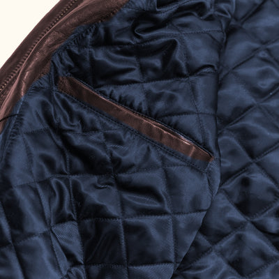 Glenwood Leather Driving Jacket in Mahogany Brown, inside welt pocket with leather trim on the navy quilted lining.