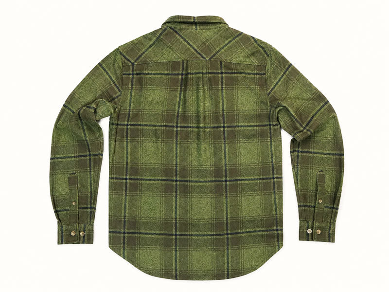 An olive green long-sleeve plaid button-down shirt with a chest pocket, laid flat against a light cream background.