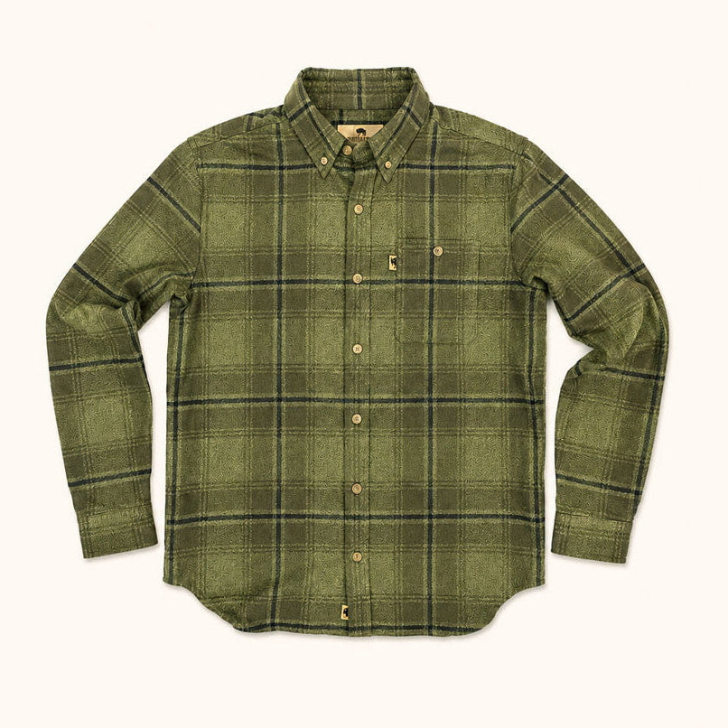 An olive green long-sleeve plaid button-down shirt with a chest pocket, laid flat against a light cream background.