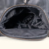 Black leather duffle bag interior, featuring a large, lined compartment for easy packing.