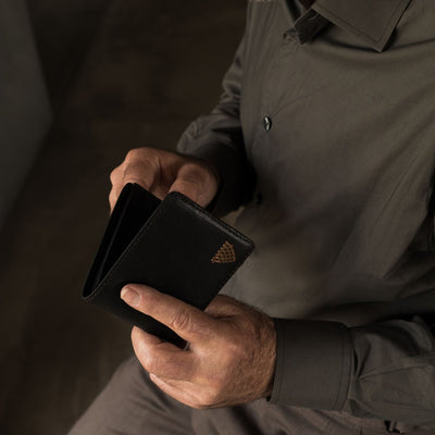 Man opening the Jefferson Leather Bifold Wallet in Vintage Black.