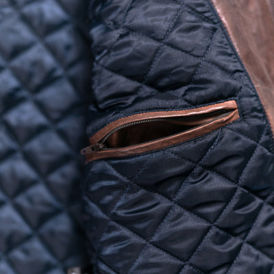 Classic quilted leather jacket in a striking mahogany brown, perfect for adding a touch of luxury to any outfit.