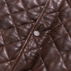 Classic mahogany brown quilted leather vest with a modern design, including practical pockets and high neck.
