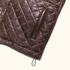 Front view of a brown quilted leather vest, showcasing its stylish and functional design.