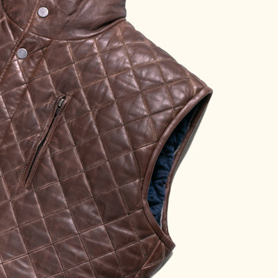Elegant brown leather vest with diamond quilting and a high collar, perfect for layering.
