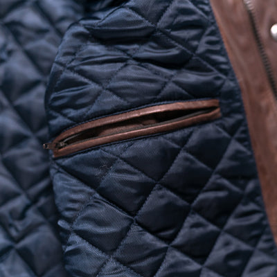Versatile quilted leather vest in a deep mahogany hue, featuring a high collar and snap closures.