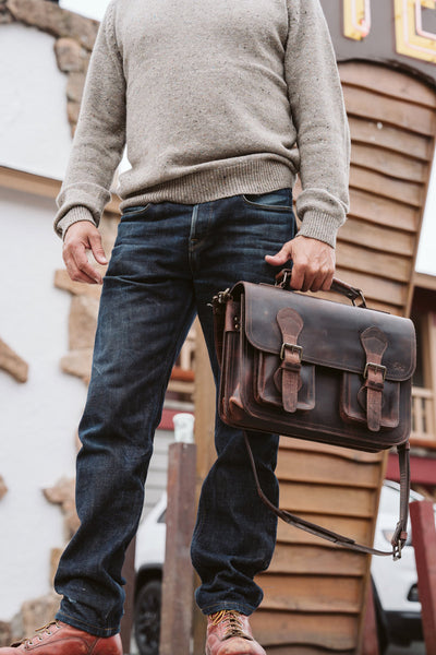 Dark oak leather Roosevelt briefcase, expertly crafted with secure buckles and a spacious interior for organization.