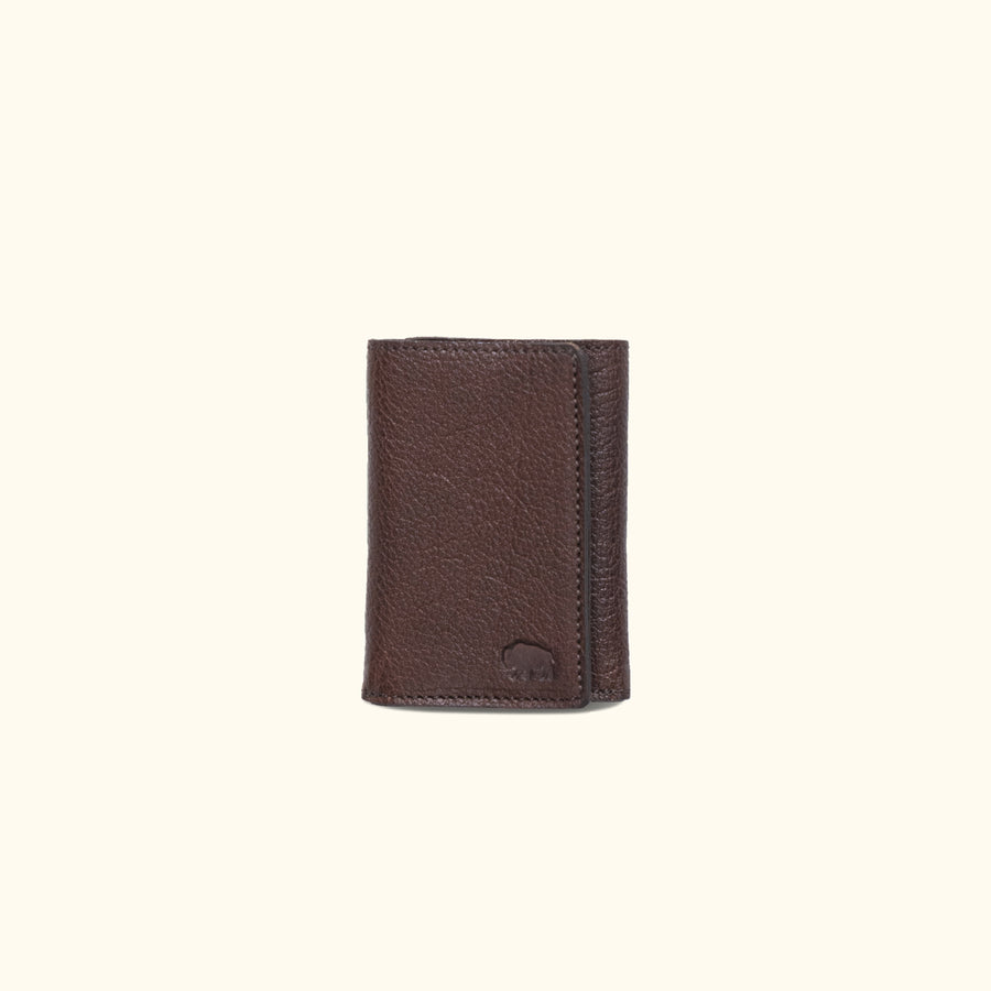 Dark brown Roosevelt bison leather trifold wallet with buffalo grain texture and compact design.