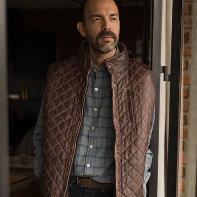 Man in a doorway wearing the Windsor Cotton Shirt in Sky Pane under a quilted leather vest