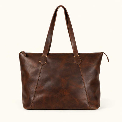 Front view of the Vintage Oak full grain leather tote bag showing the antique brass YKK top zipper and riveted handle anchors