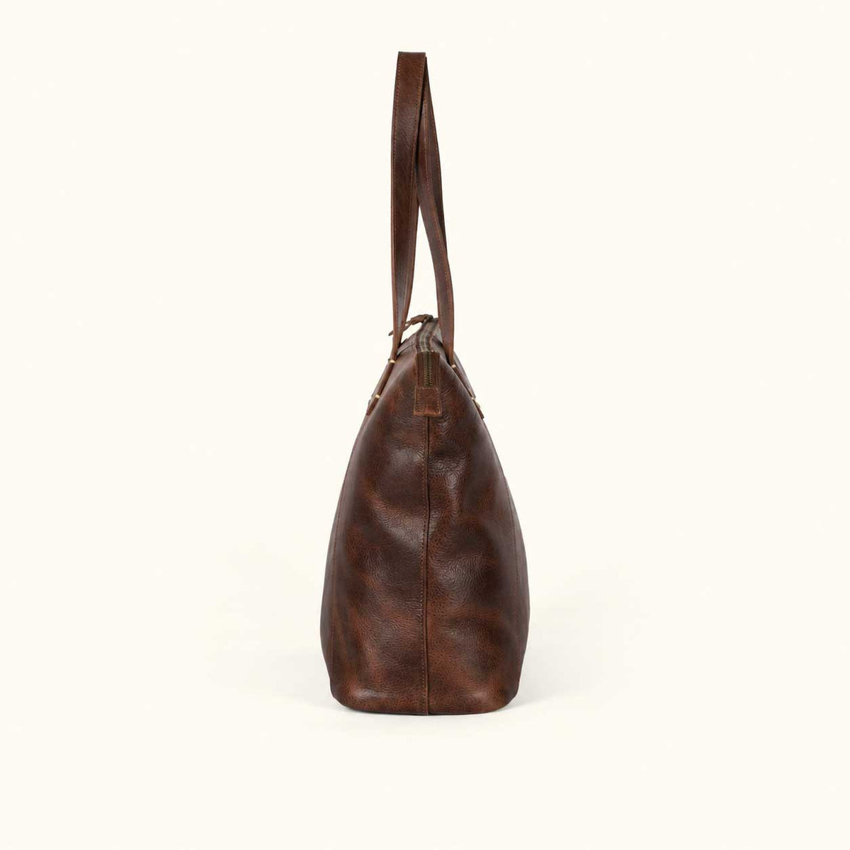 Side profile of the Walker Vintage Oak leather tote showing the 25 inch shoulder handles and full leather bottom panel