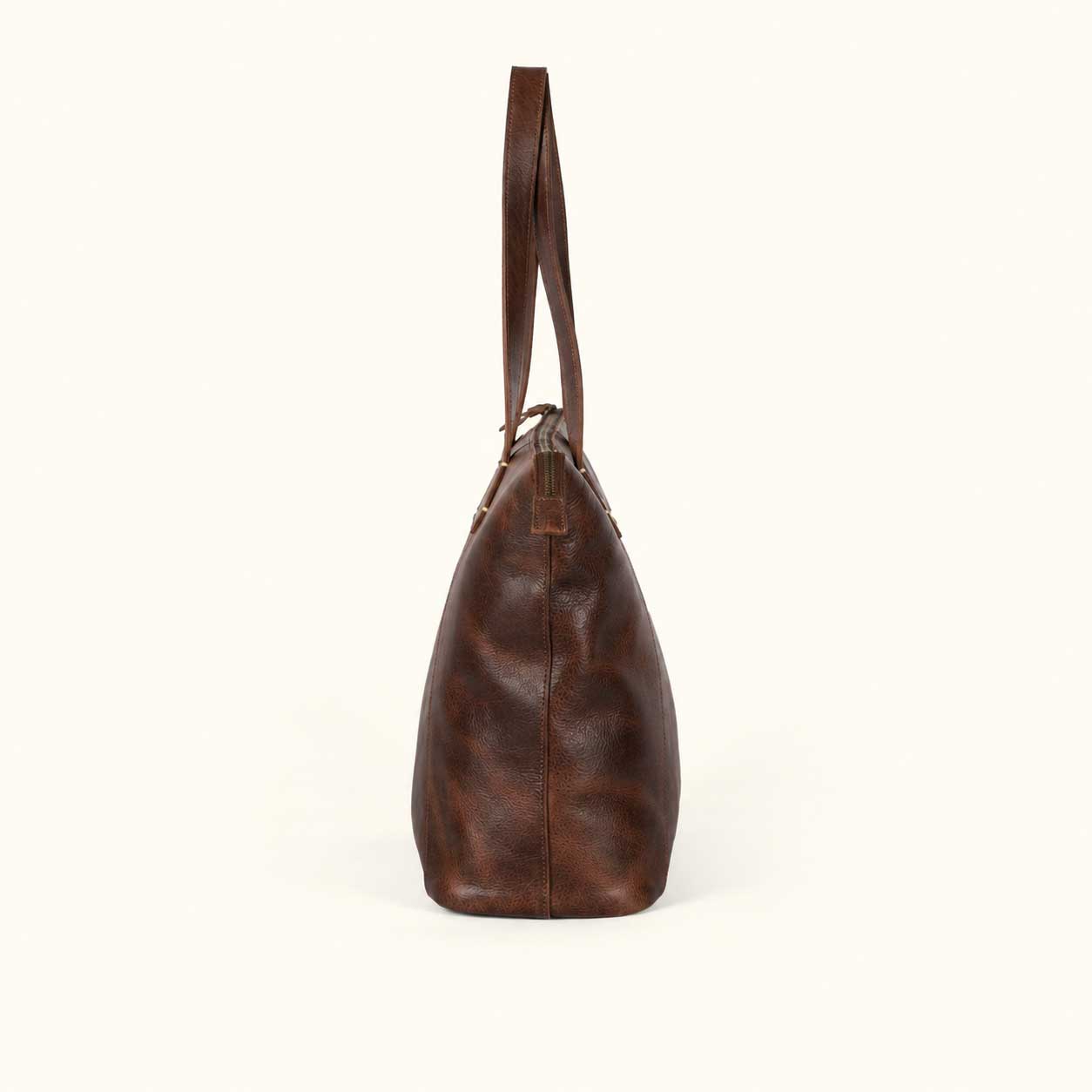 Side profile of the Walker Vintage Oak leather tote showing the 25 inch shoulder handles and full leather bottom panel