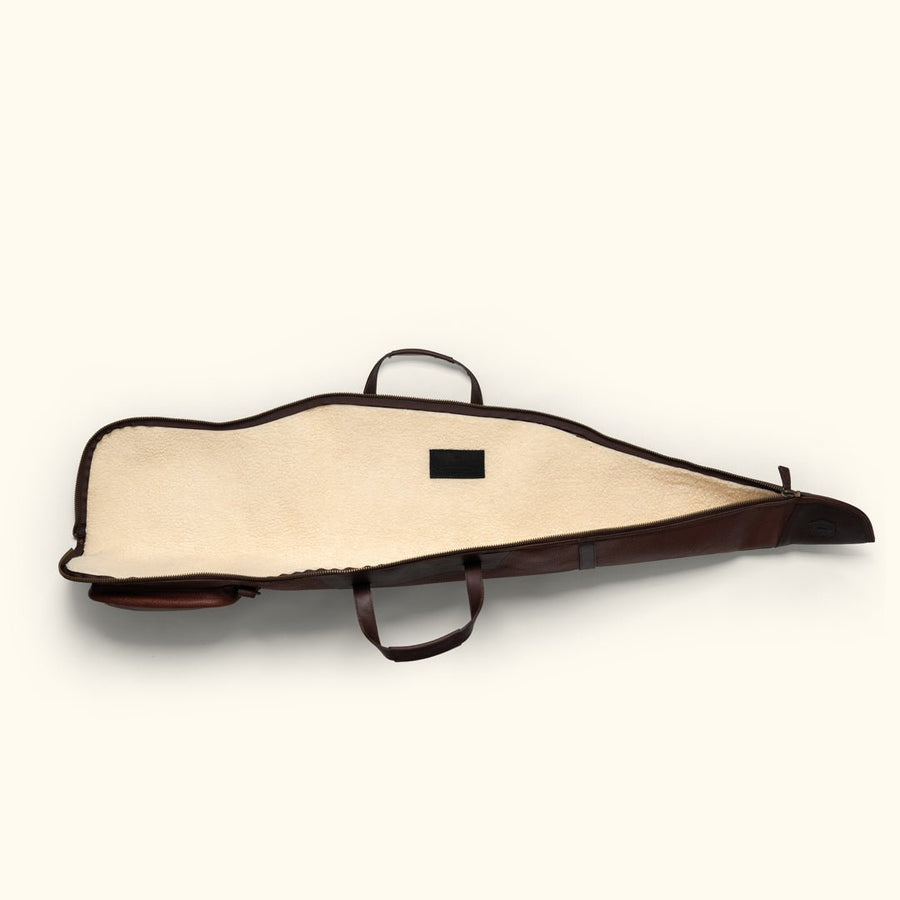 Open leather rifle case laid flat showing the full length of the cream sherpa lining