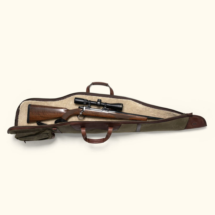 Open waxed canvas rifle case with a scoped rifle resting on the sherpa lining