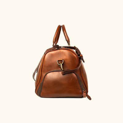 Elderwood Side Angle - Classic leather duffle bag in soft tan, featuring a polished look with practical storage solutions.