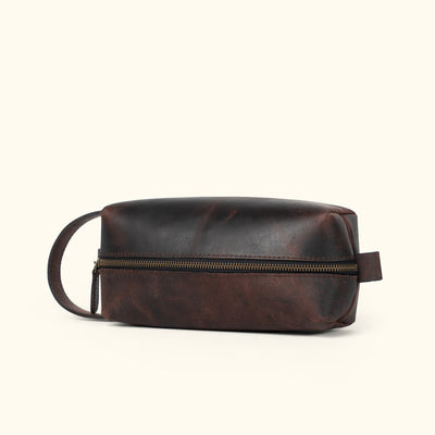 Luxury dark oak leather dopp kit featuring a classic style and fine craftsmanship.