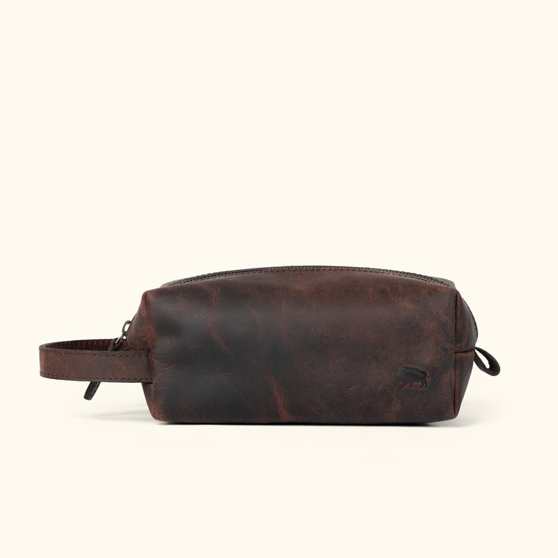 Roosevelt buffalo leather dopp kit in dark oak with dual zipper pulls and wipe-clean lining, a third anniversary travel gift for him