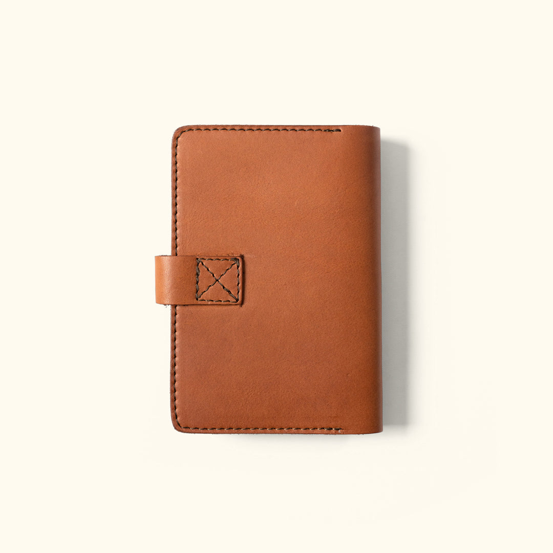 Classic brown leather journal cover with a secure strap and fine craftsmanship.
