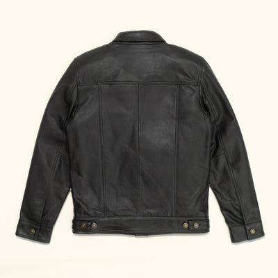 Back view of a black leather trucker jacket, showcasing its sleek design and detailed stitching.