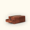 Luxurious buffalo leather travel dopp kit in amber brown with a practical design and durable build.