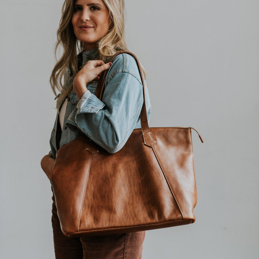 Walker rustic tan leather tote bag, front view with both handles upright